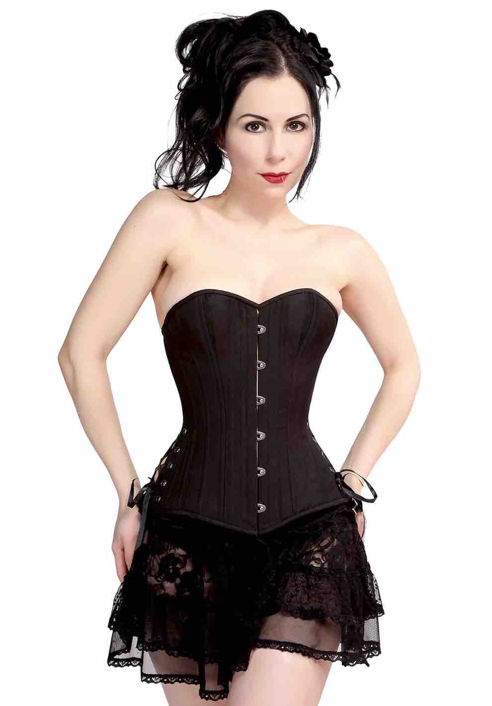 A model wearing the Black Cotton Cashmere Slim Corset over a black lace skirt.