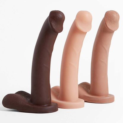 The light, medium and dark Admiral Dual Density Dildos standing upright in a row.