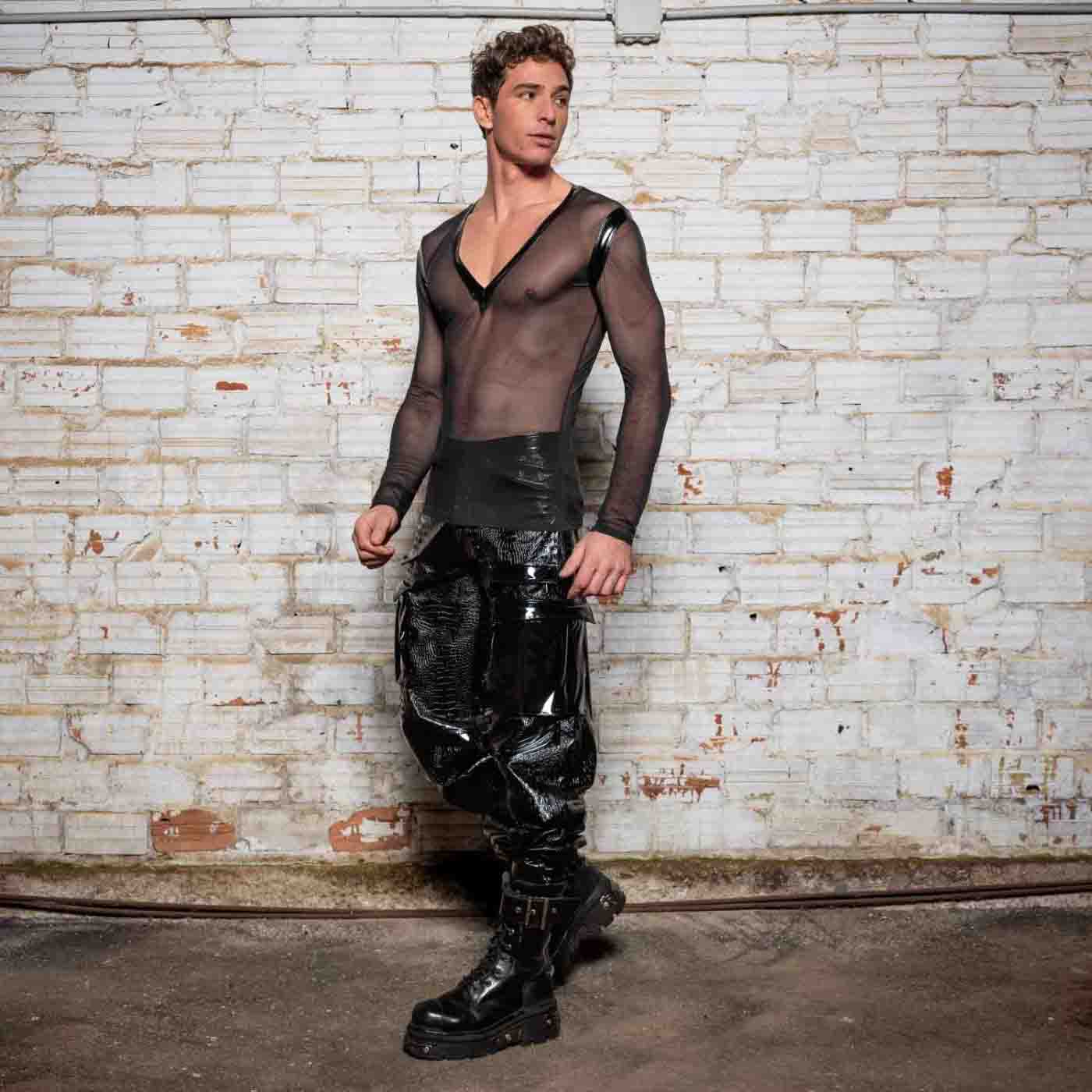 The Ali Mesh Fishnet & Patent V Neck Long Sleeve T-Shirt on model wearing black patent leather pants and combat boots, front view.