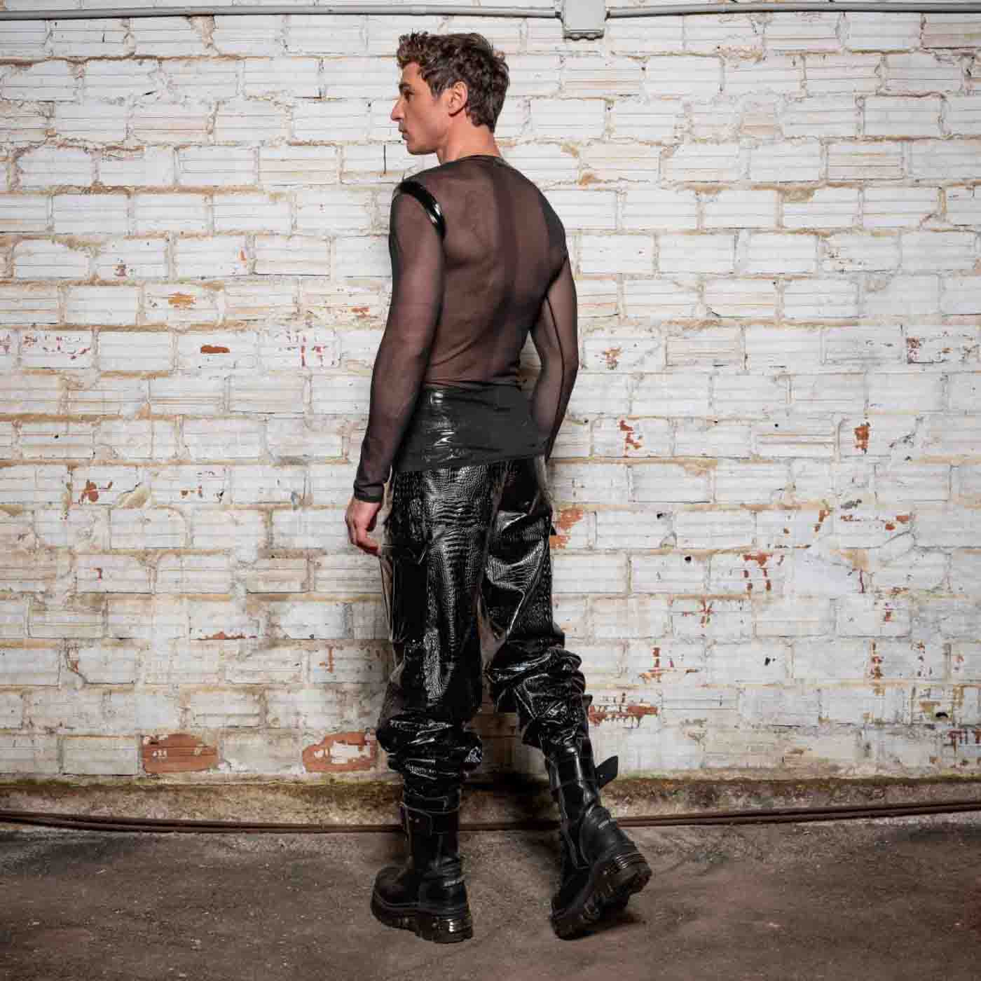 The Ali Mesh Fishnet & Patent V Neck Long Sleeve T-Shirt on model wearing black patent leather pants and combat boots, rear view.