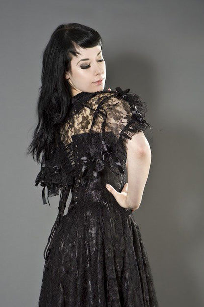 A model wearing the black Amy Gothic Bolero Shrug over a black corset and lace skirt, rear view.