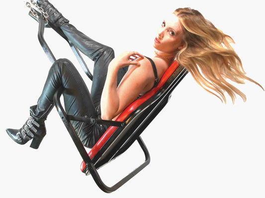 A model wearing a leather outfit laying in the red Sling Swing Model A.