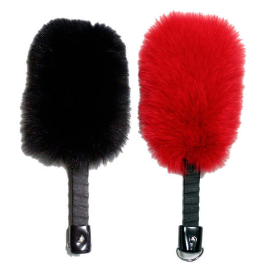 The fur side of a black and a red Fox Fur and Leather Paddle.