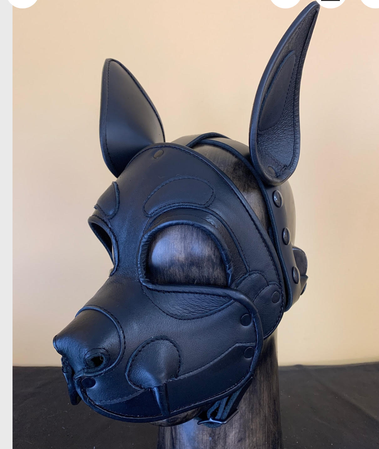The Leather Shadow Demon Dog Mask on a mannequin head, left side view.