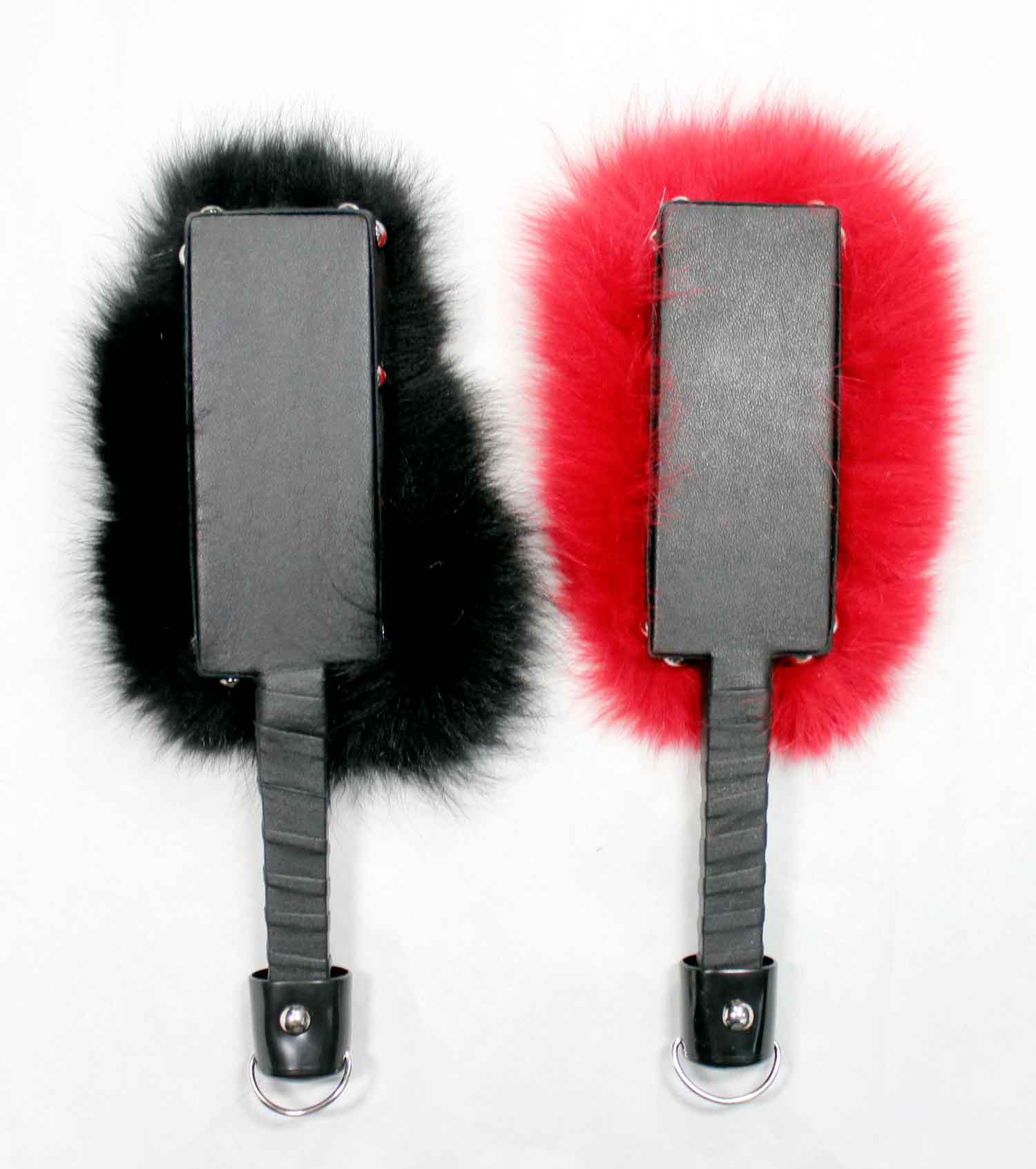 The leather paddle side of the black and the red Fox Fur and Leather Paddle.