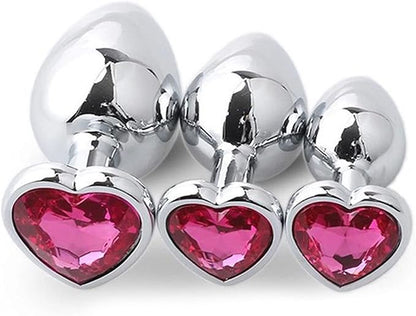 Three Steel Heart Jewel Anal Plugs of different sizes with hot pink heart jewels.
