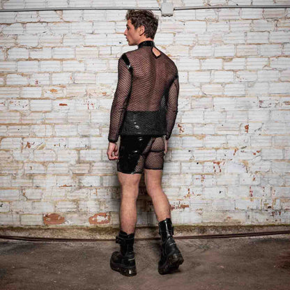 A model wearing the Leif Net & PatentT-Shirt with black patent and net shorts and black combat boots, rear view.