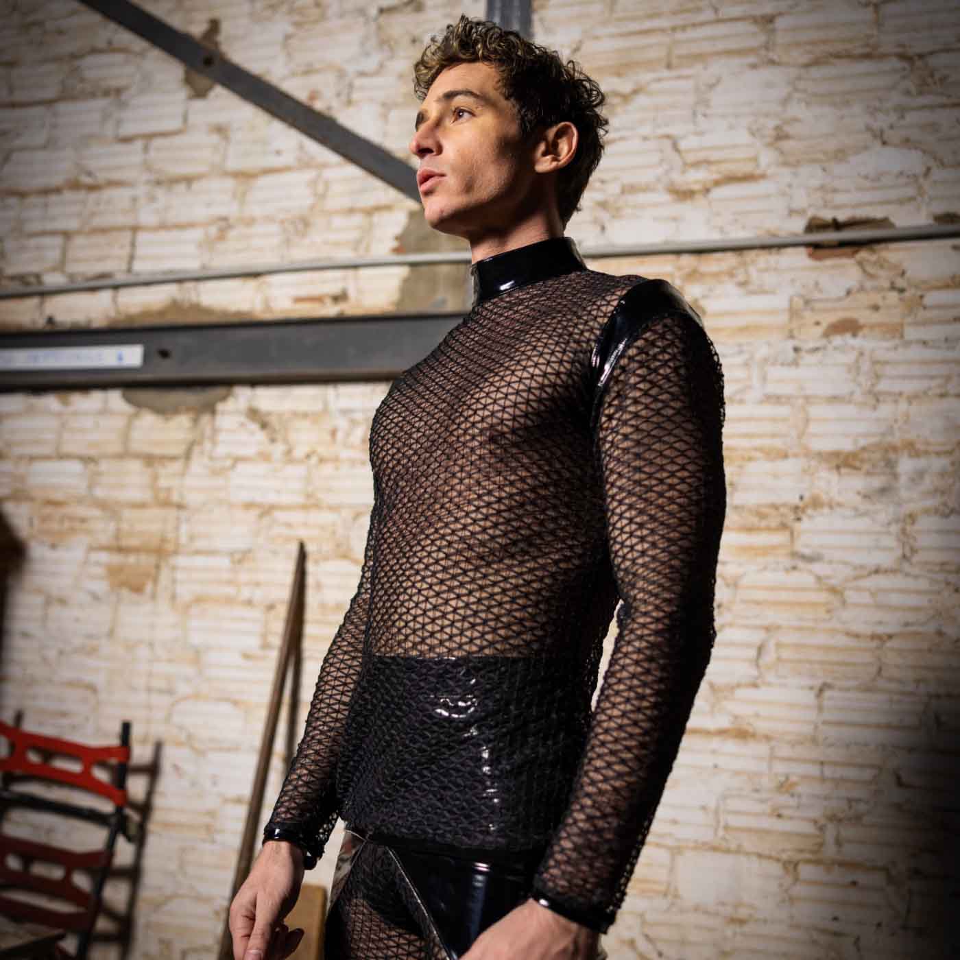 A model wearing the Leif Net & PatentT-Shirt with black patent and net shorts, front and left side view.