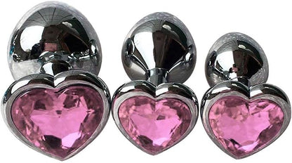 Three Steel Heart Jewel Anal Plugs of different sizes with light pink heart jewels.