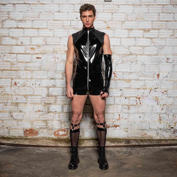 A model wearing the Anders Wetlook & Patent Playsuit with socks, garter and combat boots, front view.