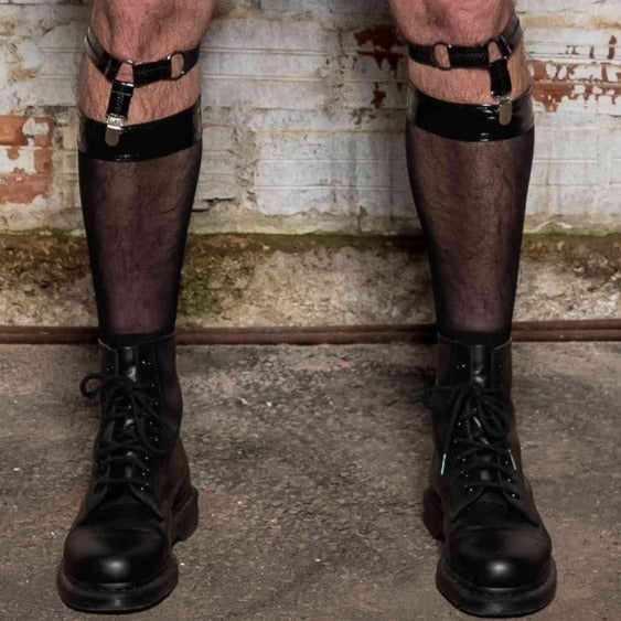 A model's legs wearing the Ali Fishnet Socks with Ali sock garters and combat boots, front view.