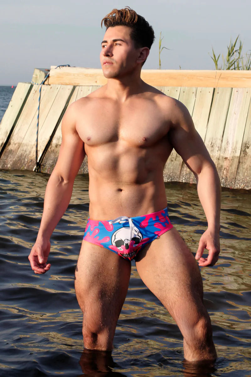 Model standing in water wearing Skull Pop briefs front view.