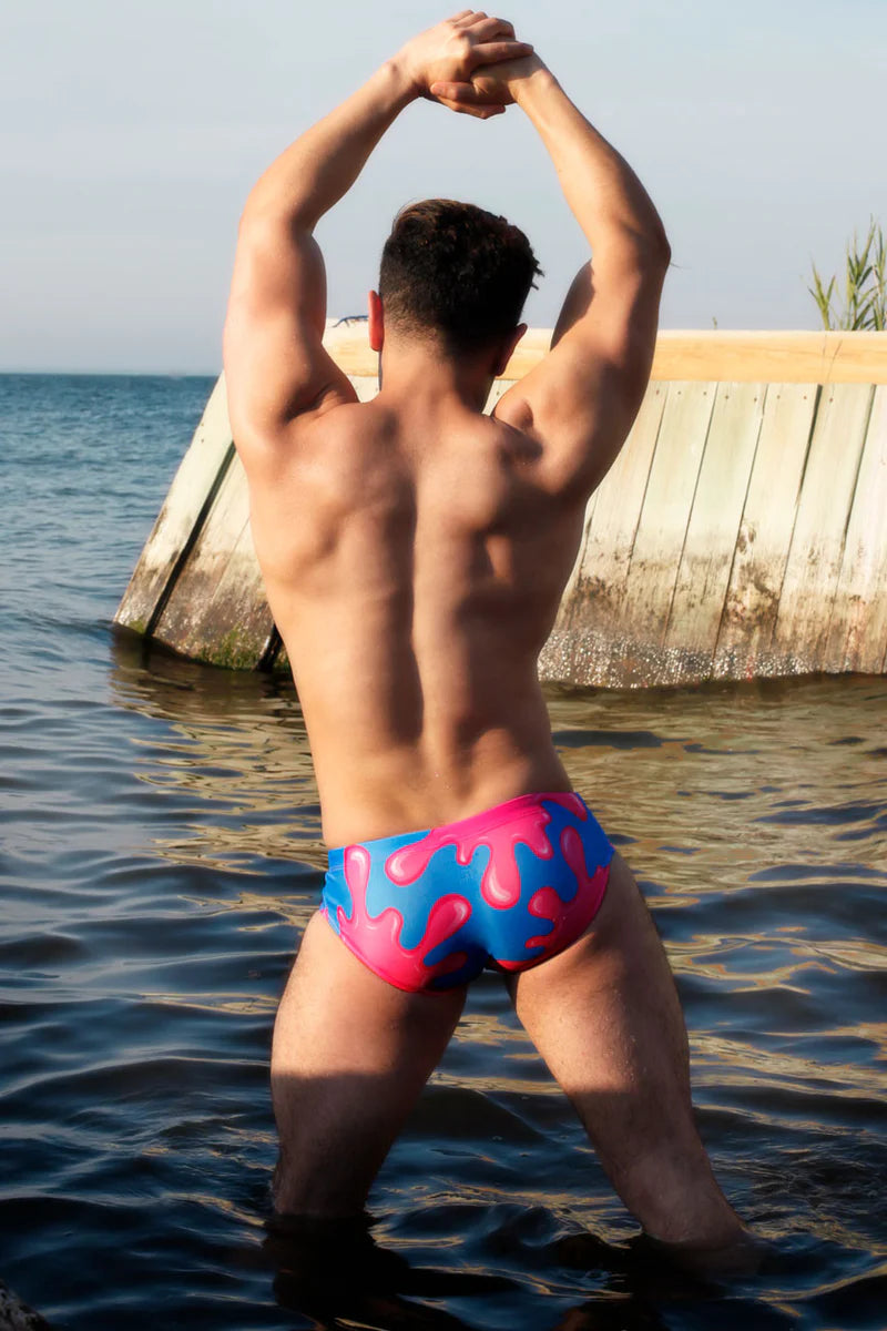 Model standing in water wearing Skull Pop briefs back view.