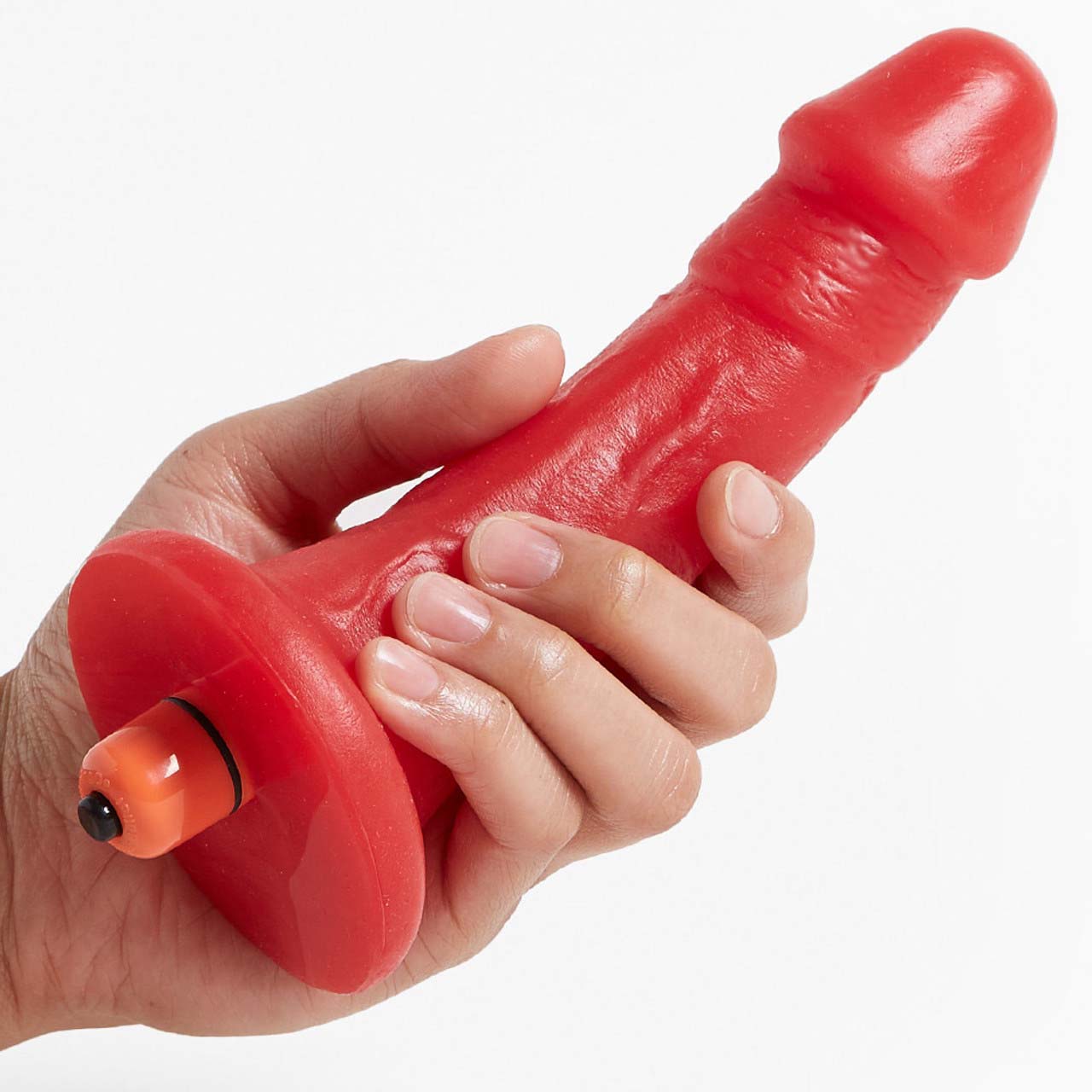 A hand holding the red Woody Silicone Dildo with vibrating bullet in it.