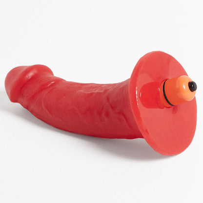 The bottom side of the red Woody Silicone Dildo with vibrating bullet in it.