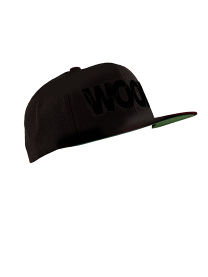 The black Woof Cap with black letters and K-Ear Snaps.