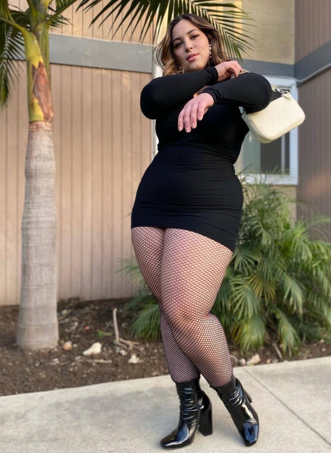 Spandex industrial net pantyhose in black on plus size model.