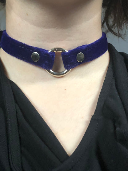 A close up of a model displaying the blue Velvet Choker.