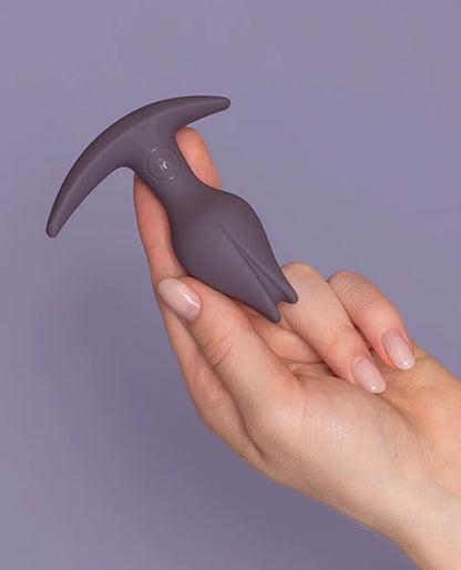 The Bootie Fem Plug in Dark Taupe color, side view in model's hand.