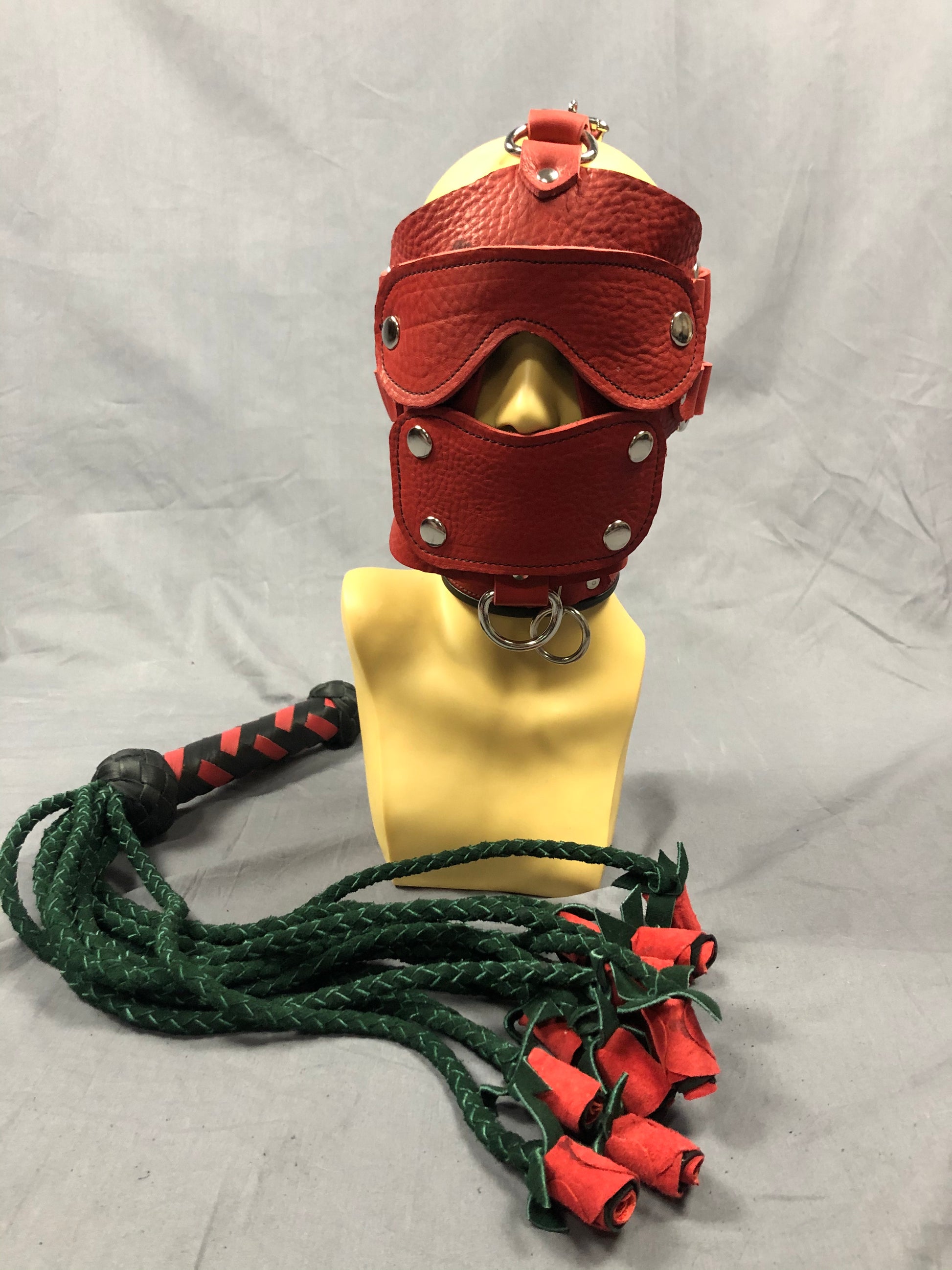 Front view of red bullhide red head harness and rose flogger