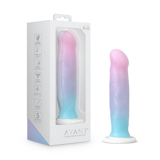 The unicorn colored Avant D17 Lucky Dildo standing upright on its suction cup next to its packaging.