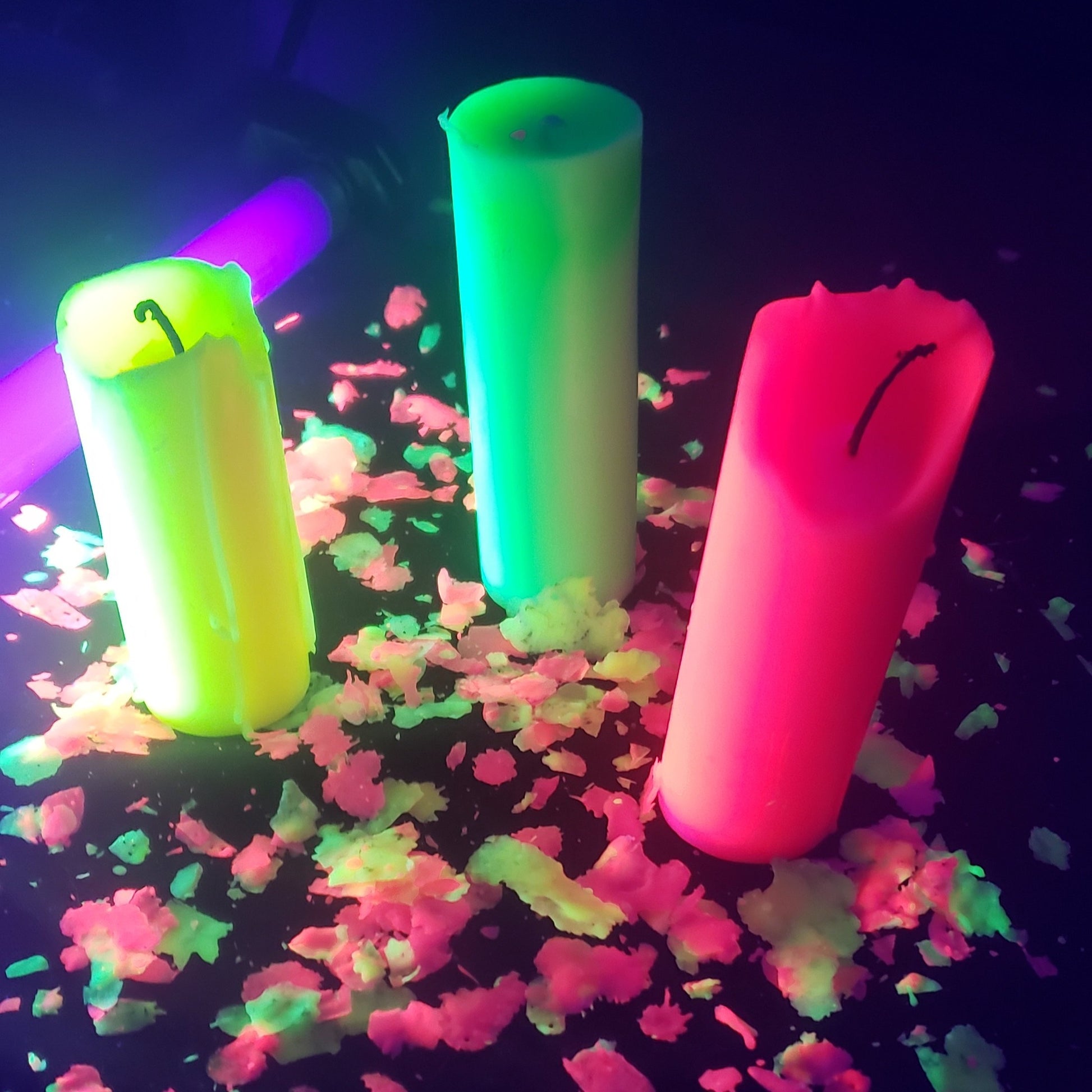 Three different colored Neon Unscented Paraffin Play Pillar Candles.