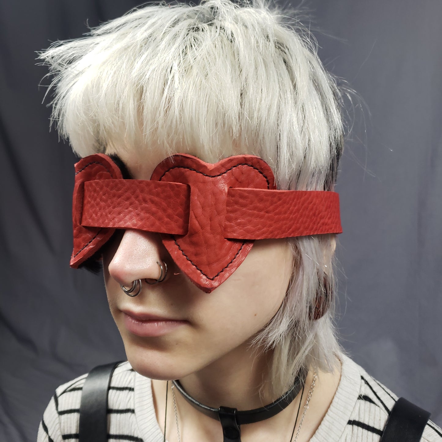A model wearing the Red Leather Heart Eye Muffs.