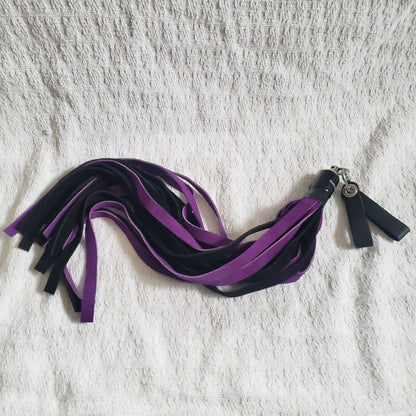 The purple and black suede finger loop flogger.