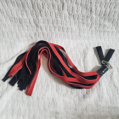 The  red and black suede finger loop flogger.