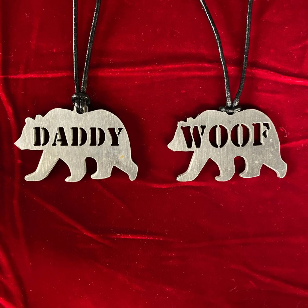Two Steel Bear Tags; one says DADDY, the other, WOOF.