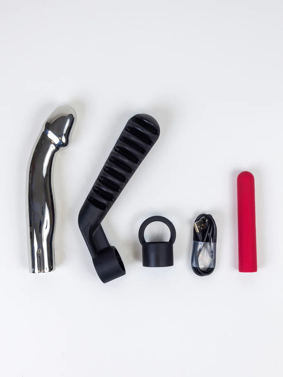 The Capo Stainless Steel Vibrating Dildo and its attachments.