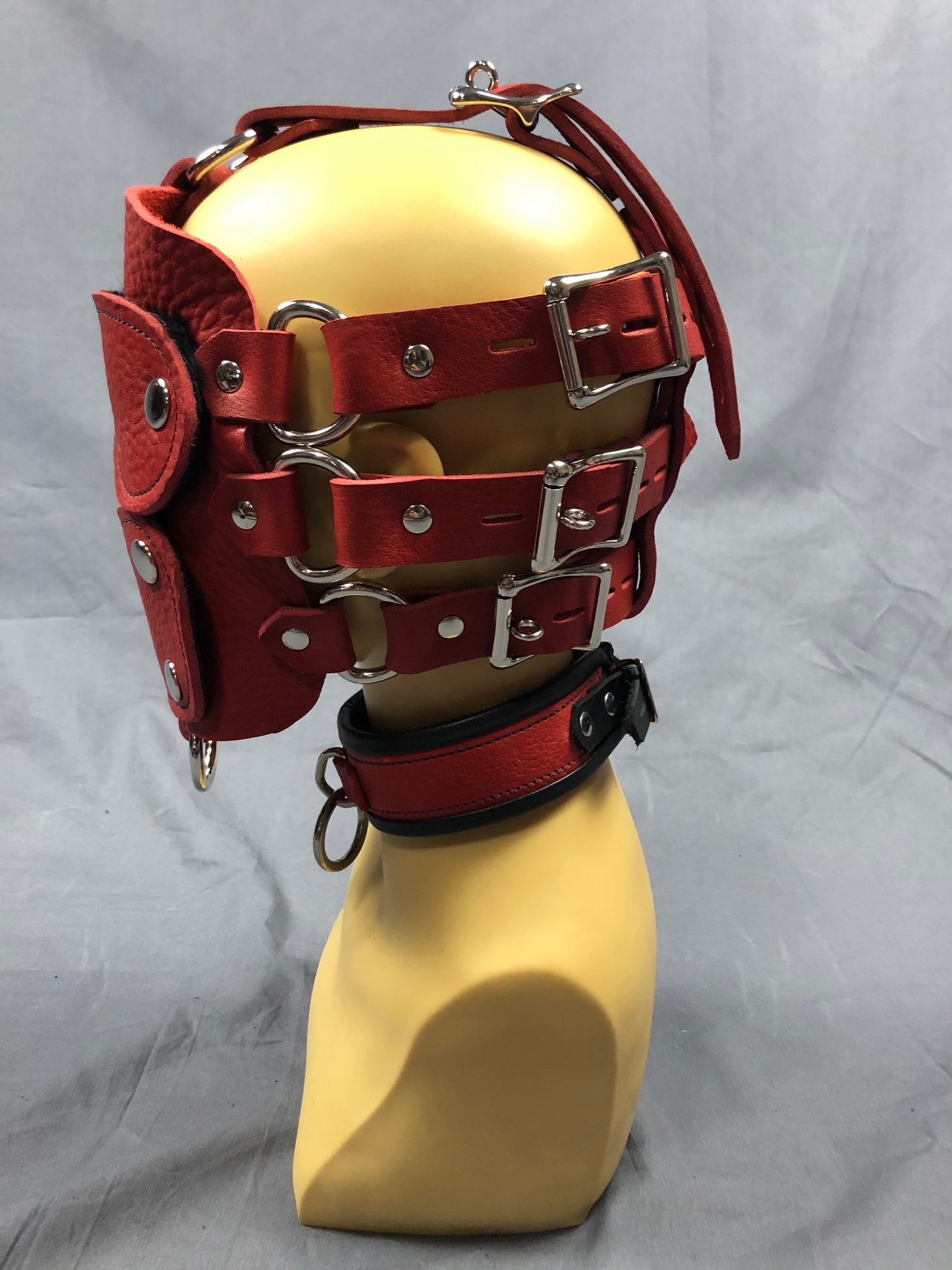 Side view of buckles of red bullhide head harness