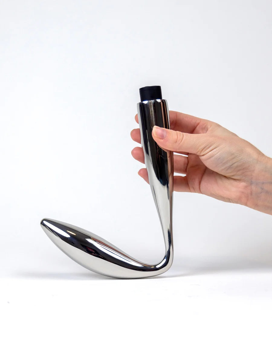 A model's hand holding the Reverb Stainless Steel Vibrating Anal Dildo.