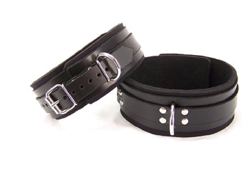 Black leather thigh cuffs, featuring the buckle closure and D-rings against a white background.