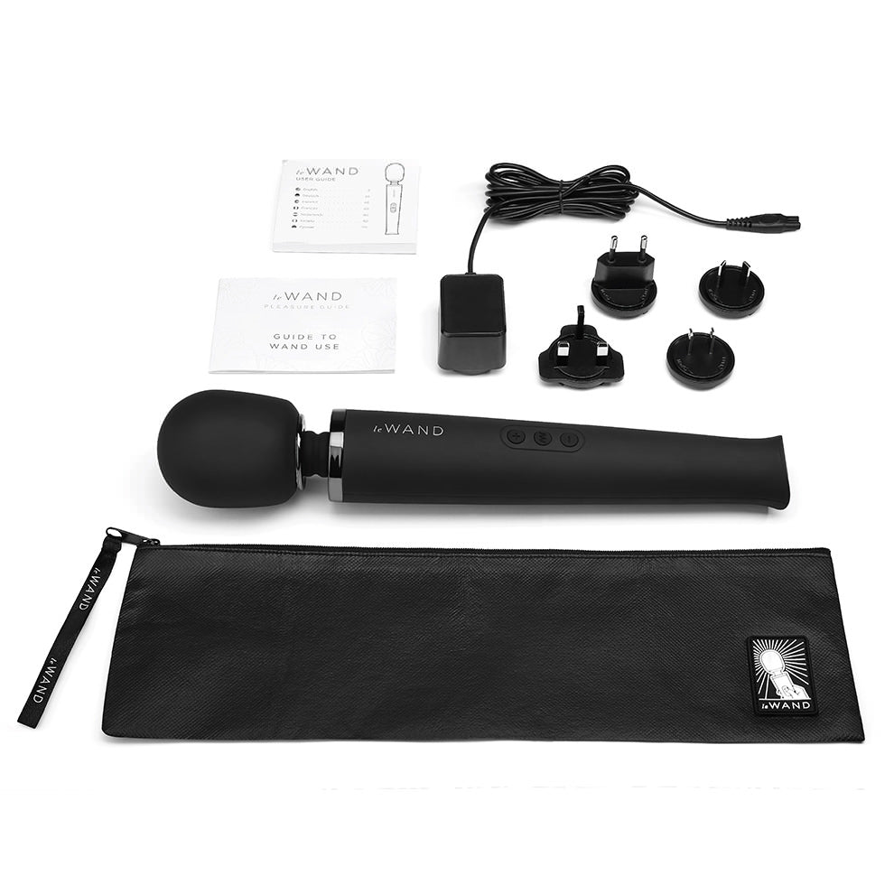 The black Le Wand Rechargeable Vibrator and its accesories.