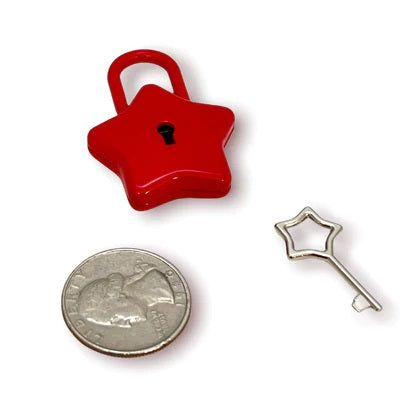 The red Star Lock and key next to a quarter for size comparison.