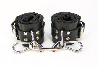 Black satin lined bondage cuffs with double snap clip connecting the cuffs.
