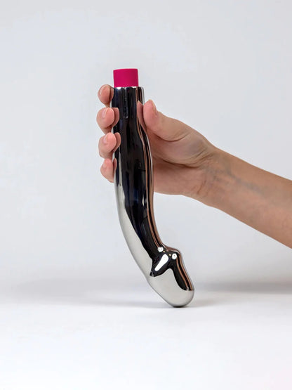 A hand holding the Capo Stainless Steel Vibrating Dildo.
