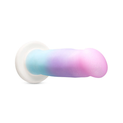 The unicorn colored Avant D17 Lucky Dildo laying on its side with the head pointed toward the front of the photo.