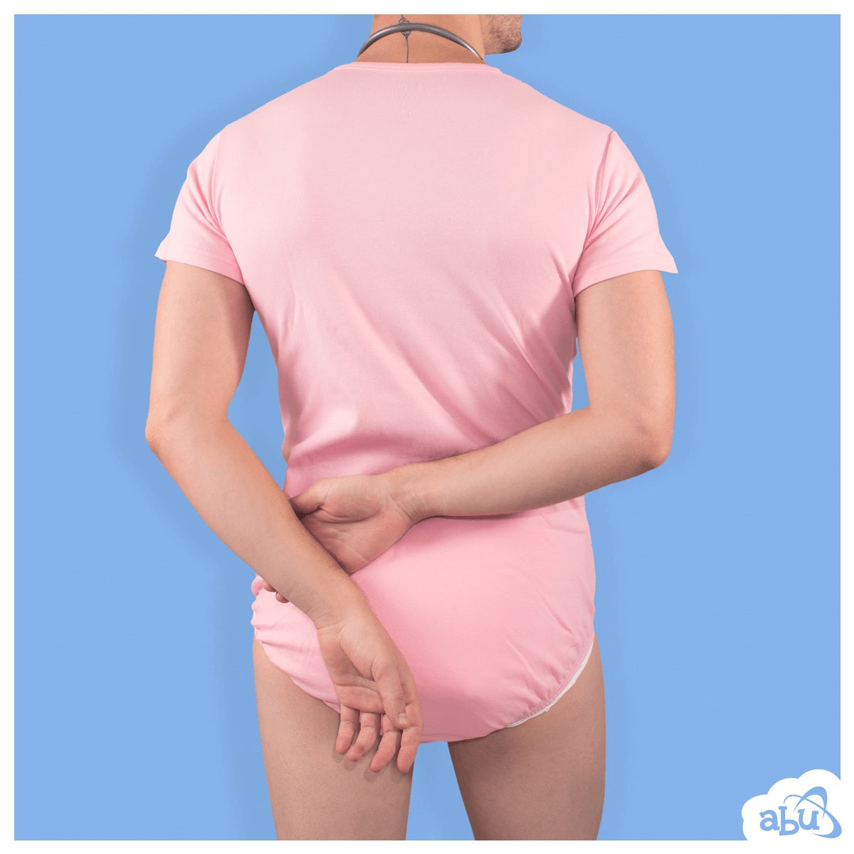 Rear view of model wearing baby pink diapersuit with disposable diaper worn underneath
