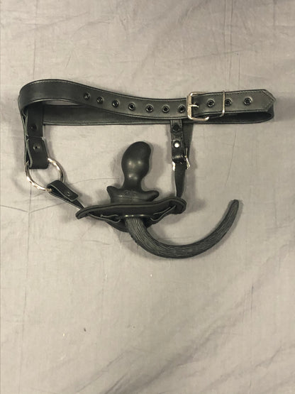 View of leather puppy tail holster with pup tail plug inserted