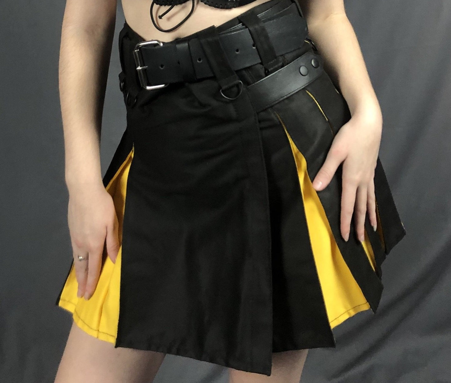 Black and yellow Mini Contrast Pleat Heritage Kilt, front view.