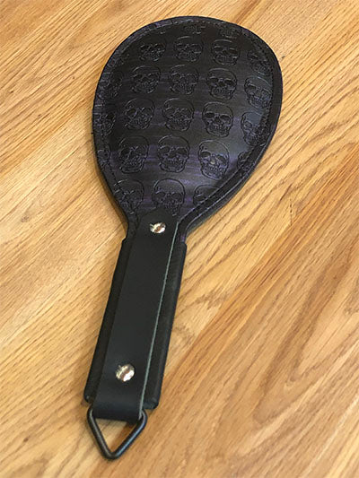 Black and purple round paddle with skull print.