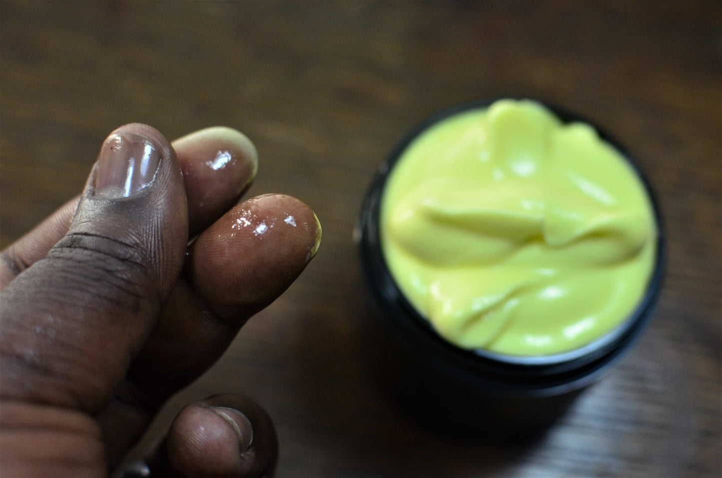 Close up of a models fingers feeling texture of lube between fingers.