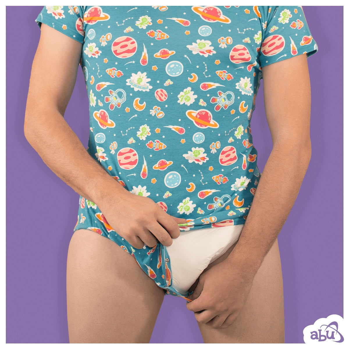 Photo of model wearing space print diapersuit and holding snaps at crotch partially open showing disposable diaper worn underneath.