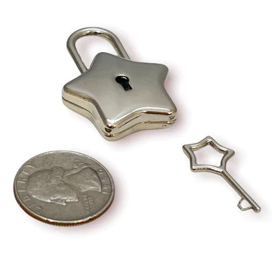The silver Star Lock and key next to a quarter for size comparison.