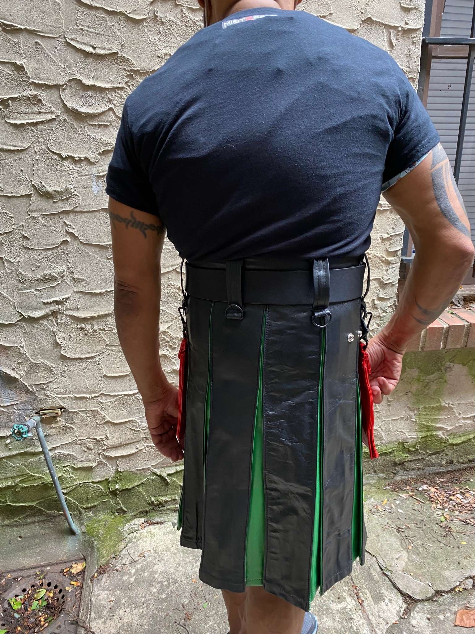 Model showing the back of the leather boy pride flag heritage Kilt.