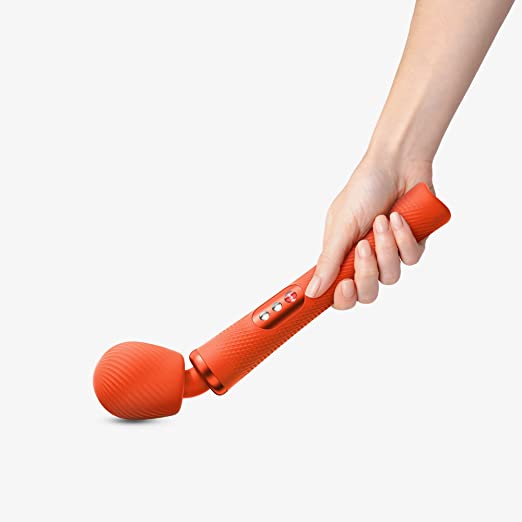 A hand holding and pressing the head of the Sunrise Orange VIM Wand against a surface to show its bendability.