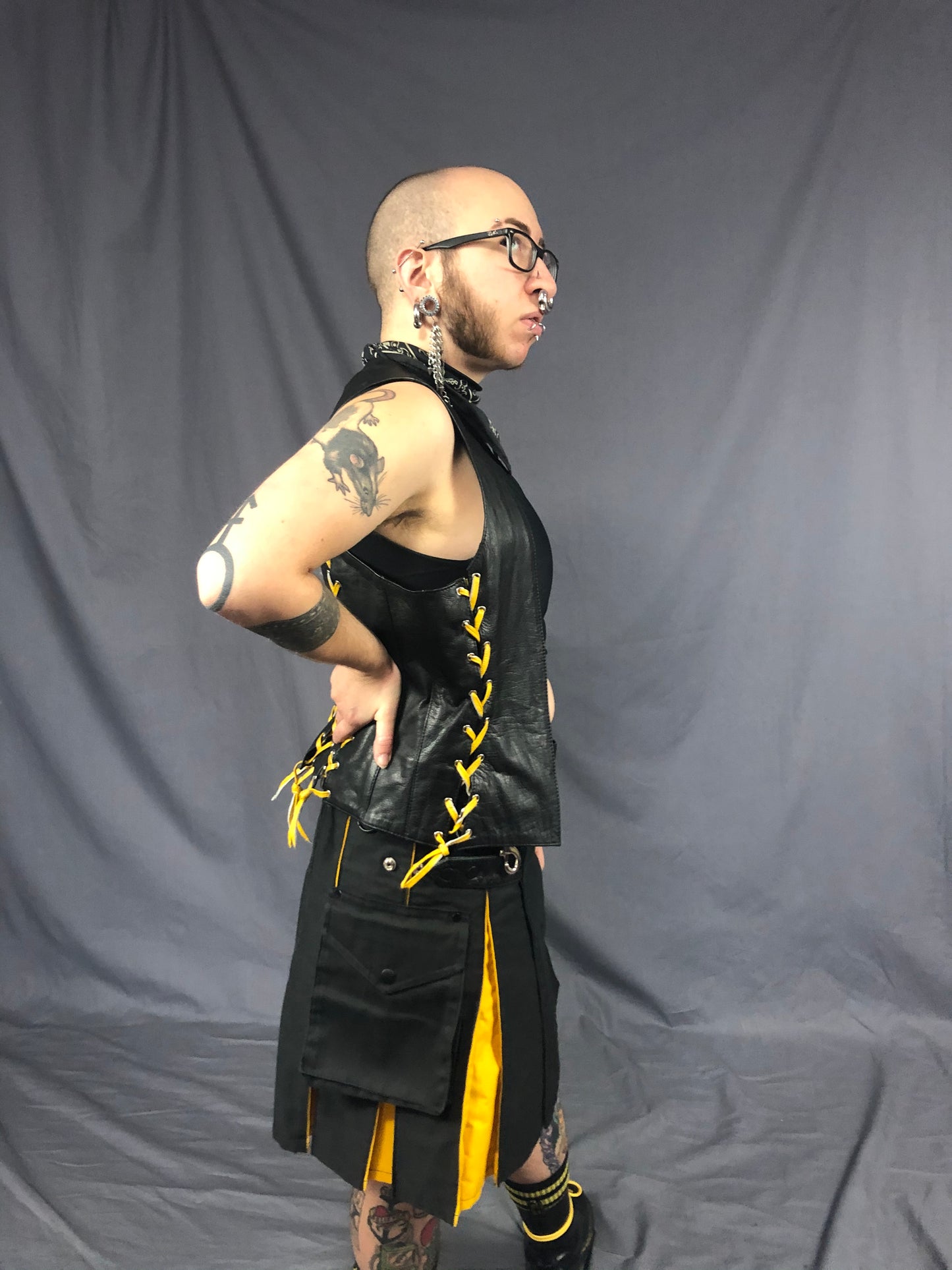 Right side view of black/yellow contrast pleat cargo kilt