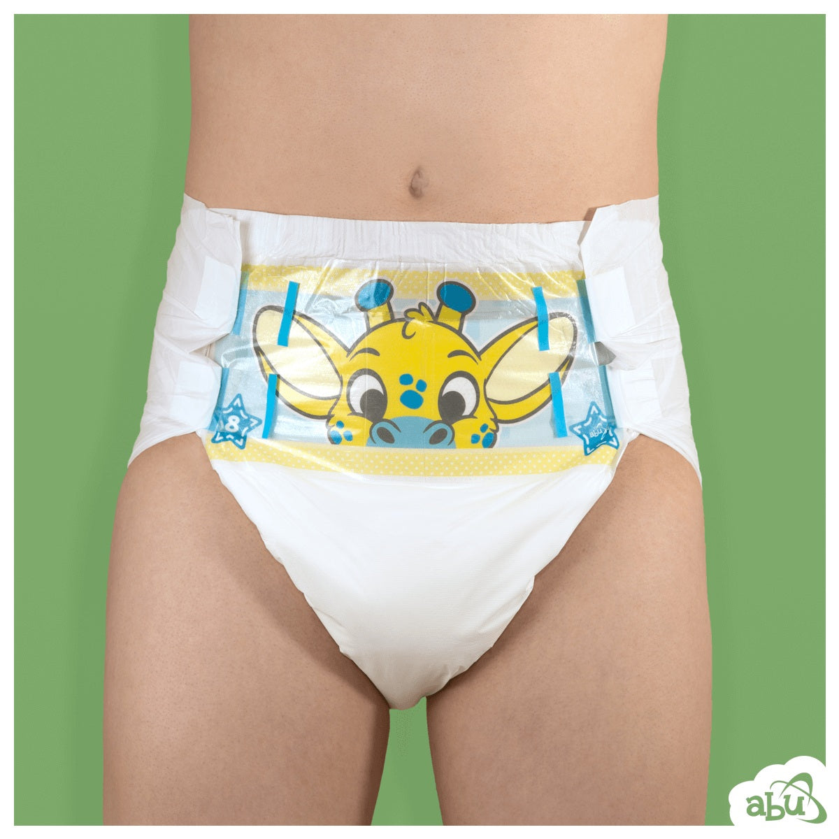 Front view of diaper on model with yellow giraffe character printed on front.